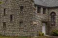 Old vintage stone texture building air conditioner in window