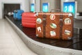 Old vintage suitcase on a airport luggage conveyor belt. Baggage claim. Travel and tourism concept background Royalty Free Stock Photo