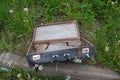Old vintage suitcase lying on the grass Royalty Free Stock Photo