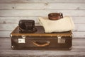 Old vintage suitcase in the room on wooden light board. Royalty Free Stock Photo