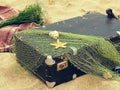 Old vintage suitcase for travel and family vacations lies on the beach. Sea shore ocean. Photo in a trendy retro style Royalty Free Stock Photo