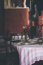 Old vintage table and traditional chairs and water pot and flowers Royalty Free Stock Photo