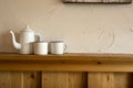 Old vintage teapot and two cup of tea on wooden shelf, antique Royalty Free Stock Photo