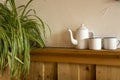 Old vintage teapot and two cup of tea on wooden shelf, antique Royalty Free Stock Photo