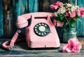 Old vintage telephone with dialer on a wooden table. Nostalgic moods