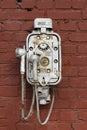 Old vintage telephone on a street brick wall. Steampunk technology, design, retro style concept. Royalty Free Stock Photo