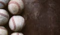 Old used baseball balls on wood texture brown background with copy space for sport Royalty Free Stock Photo