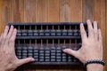 Old Vintage tone of Man's hands accounting with old abacus and hold electronic calculator. picture financial concept design Royalty Free Stock Photo