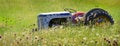 Old Vintage Tractor Antique in Field with Flowers Abandoned Royalty Free Stock Photo