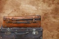 Old vintage travel suitcases over brown leather