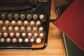 Old and vintage type writer machine and piles of books on wooden Royalty Free Stock Photo