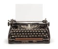 Old vintage typewriter and a blank sheet of paper inserted. Isolated on white background Royalty Free Stock Photo