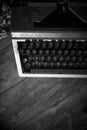 Old vintage typewriter on a desk, cinematic noir scene Royalty Free Stock Photo