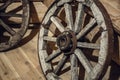 Old vintage wagon wheels at wooden wall in rural house Royalty Free Stock Photo