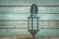 Old vintage wall lamp on wooden wall in vintage style. Royalty Free Stock Photo