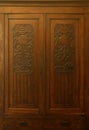 Old vintage wardrobe furniture with ornamental doors and retro colors of wooden surfaces Royalty Free Stock Photo