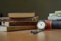 Old vintage watch and some books on a table Royalty Free Stock Photo