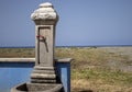 Old vintage water faucet on the beach on the Italian coast in sunny Calabria, Italy. Tap water against the beach. Faucet with