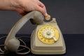 old vintage wheel phone and hand with telephone token. Royalty Free Stock Photo