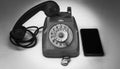 old vintage wheel phone with telephone tokens and smartphone. Old and new in comparison Royalty Free Stock Photo