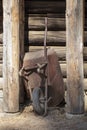 Old vintage wheelbarrowstanding on a log cabin wall Royalty Free Stock Photo