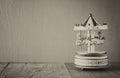 Old vintage white carousel horses on wooden table. black and white old style photo