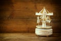 Old vintage white carousel horses on wooden table. black and white old style photo