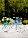 Old vintage white painted bicycle rebuilt as a flower stand for Royalty Free Stock Photo