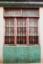 Old vintage window of house old fashion design classic on green rustic mosaic on concrete wall background Royalty Free Stock Photo