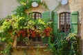 Old vintage windows with flowers and wooden green shutters in the old house of Provence French village. Royalty Free Stock Photo