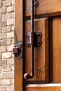 Old vintage wood door lock lock rusty brown brick wall forged wooden gate valve latch bolt catch