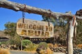 vintage wood signboard with text welcome to Abuja. hanging on a branch