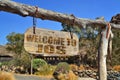 vintage wood signboard with text welcome to Jos. hanging on a branch