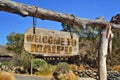 old vintage wood signboard with text welcome to Maipu hanging on a branch