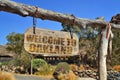 Old wood signboard with text welcome to Oakland. hanging on a branch