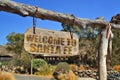 old wood signboard with text welcome to santa fe. hanging on a branch