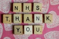 Old worn vintage wooden textured cubes spelling out NHS, the British National health Service,