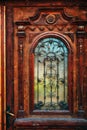 Old vintage wooden door with carving decoration and wrought iron details Royalty Free Stock Photo