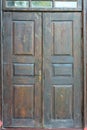 an old vintage wooden door in a Catholic church. Beautiful cast iron metal rusty vintage hinges on the gates of the Historical Royalty Free Stock Photo