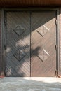 an old vintage wooden door in a Catholic church. Beautiful cast iron metal rusty vintage hinges on the gates of the Historical Royalty Free Stock Photo