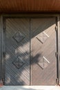 an old vintage wooden door in a Catholic church. Beautiful cast iron metal rusty vintage hinges on the gates of the Historical Royalty Free Stock Photo