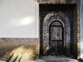 Old vintage wooden door ornamented curved bricks on concrete building.