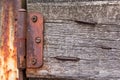 Old vintage wooden hinge on a fence with nails