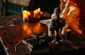 On the old vintage wooden table is a candlestick with candles. A red-haired girl in vintage clothes is sitting at the table, readi Royalty Free Stock Photo