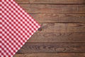 Old vintage wooden table with a red checkered tablecloth. Top view mockup.