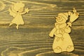 Old vintage wooden toys. Cheerful snowman with broom and figure of angel soaring in height with Christmas star on old dark natural Royalty Free Stock Photo