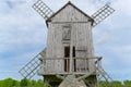 Old vintage wooden windmill in the background of the cloudy sky. Saaremaa, Estonia. Royalty Free Stock Photo