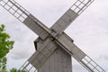 Old vintage wooden windmill in the background of the cloudy sky. Saaremaa, Estonia. Royalty Free Stock Photo