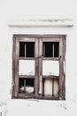 Forgotten Protection: Vintage Wooden Window with Curved Steel Bars Against a Background of Abandoned Decay