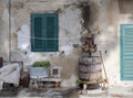 Old, vintage wooden wine press, rustic, in village street scene with other items. Bolgheri, in Tuscany, Italy. Rural Royalty Free Stock Photo
